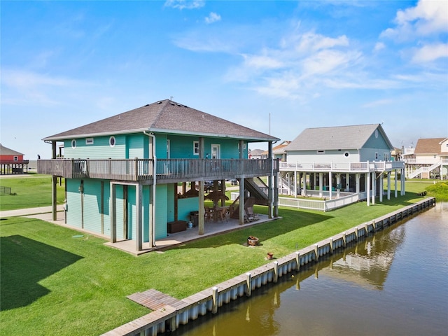 2617 Breaker Dr, Port Bolivar, TX 77650 - rear view of house with roof with shingles, a deck with water view, a patio, and a lawn