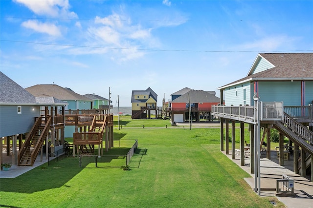 2617 Breaker Dr, Port Bolivar, TX 77650 - view of grassy yard featuring stairway, a wooden deck, and a residential view