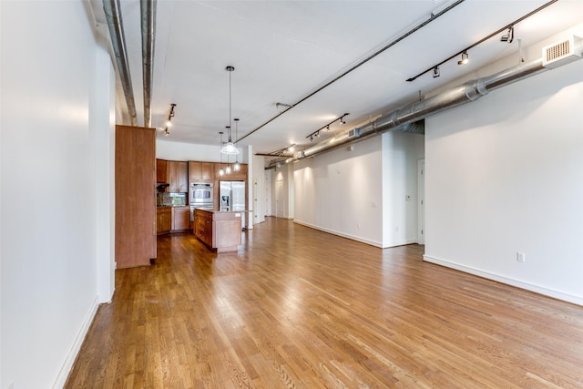 1616 Fountain View Dr Unit 202, Houston, TX 77057 - unfurnished living room featuring light wood-style floors and baseboards