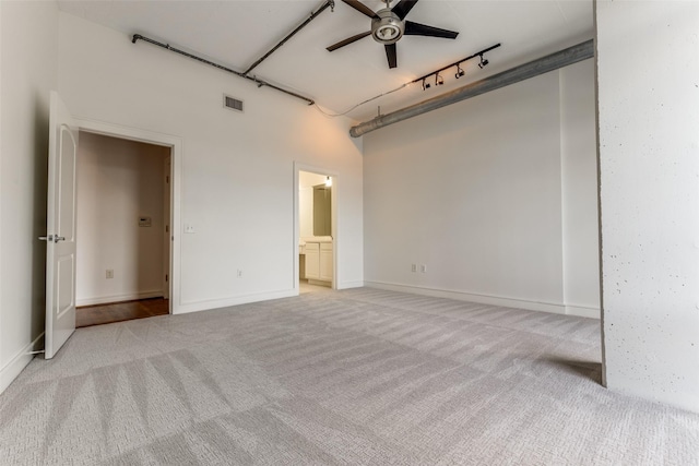 1616 Fountain View Dr Unit 202, Houston, TX 77057 - unfurnished room featuring light carpet, a ceiling fan, track lighting, and a towering ceiling