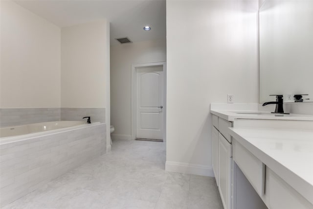 1616 Fountain View Dr Unit 202, Houston, TX 77057 - bathroom with vanity, a bath, and recessed lighting