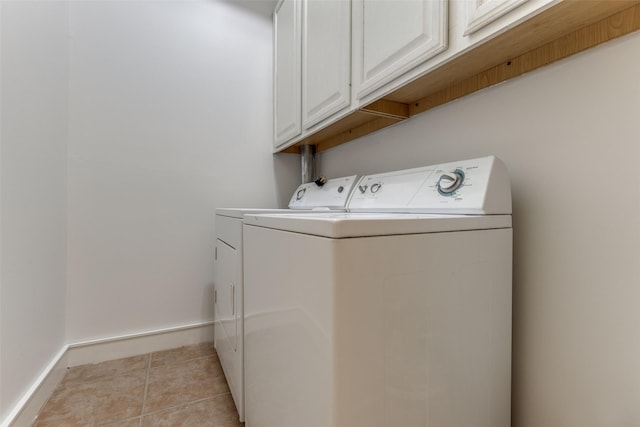 1616 Fountain View Dr Unit 202, Houston, TX 77057 - laundry area with washing machine and dryer, cabinet space, and light tile patterned floors