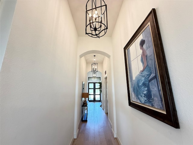 31306 Crescent Hill Dr, Fulshear, TX 77441 - corridor with arched walkways, a chandelier, and hardwood / wood-style floors