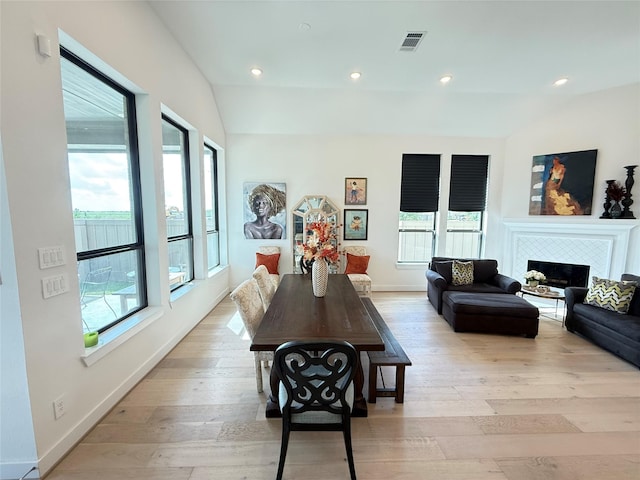 31306 Crescent Hill Dr, Fulshear, TX 77441 - dining area featuring healthy amount of natural light, light wood-type flooring, a fireplace, recessed lighting, and vaulted ceiling