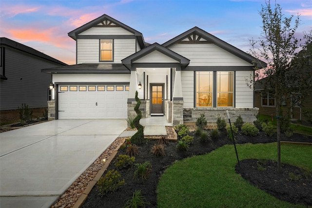 506 Fay Ct, Dayton, TX 77535 - view of front of property with stone siding, concrete driveway, and an attached garage