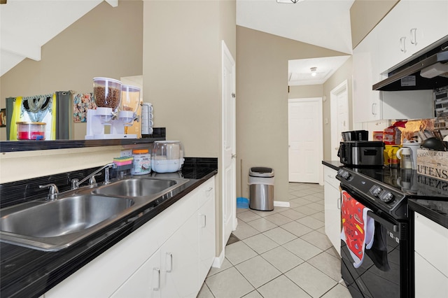19330 Cypress Canyon Dr, Katy, TX 77449 - kitchen with black range with electric stovetop, under cabinet range hood, white cabinetry, light tile patterned floors, and dark countertops