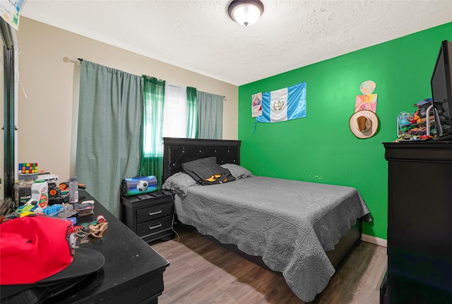 19330 Cypress Canyon Dr, Katy, TX 77449 - bedroom with wood finished floors and a textured ceiling