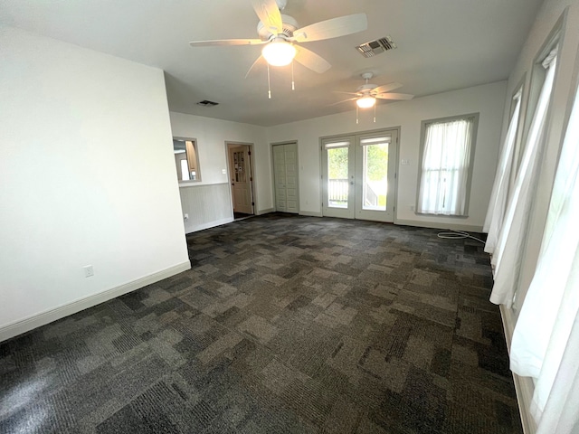 903 Bowie St, Columbus, TX 78934 - spare room with dark colored carpet, a ceiling fan, and french doors