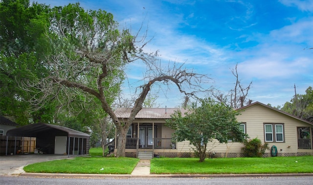 903 Bowie St, Columbus, TX 78934 - view of front of house featuring a carport, a porch, a front yard, driveway, and a metal roof