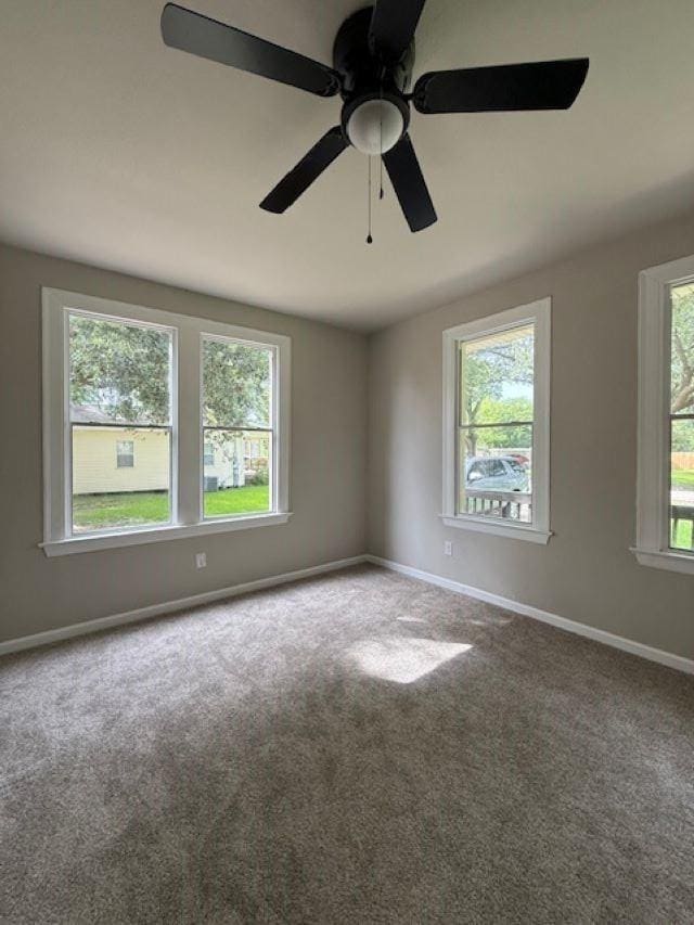403 3rd St, Nederland, TX 77627 - carpeted spare room featuring baseboards and a ceiling fan