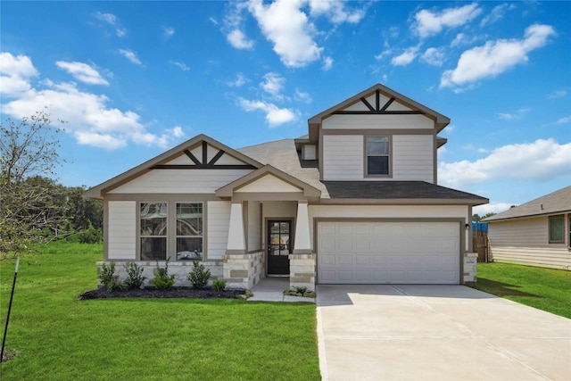 604 Danielle St, Dayton, TX 77535 - view of front of home featuring a garage, a front lawn, stone siding, and driveway