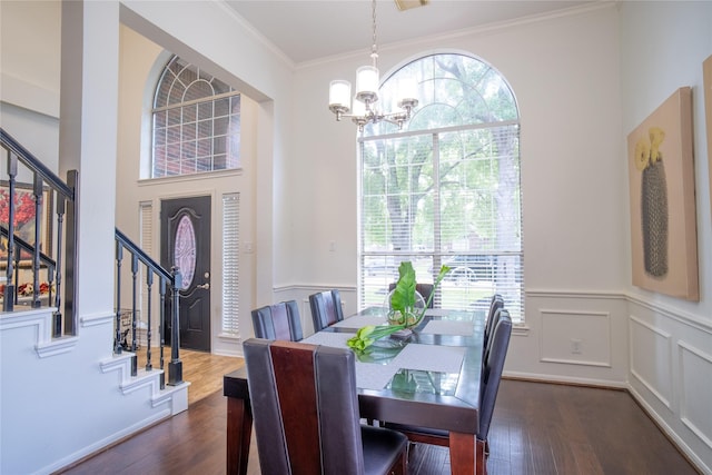 9434 Barretts Glen Ct, Houston, TX 77065 - dining area featuring a chandelier, stairway, wainscoting, dark wood-style flooring, and crown molding