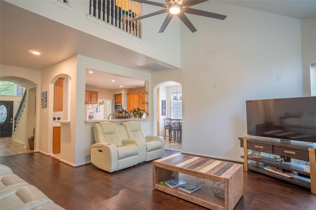 9434 Barretts Glen Ct, Houston, TX 77065 - living area with arched walkways, a ceiling fan, hardwood / wood-style flooring, a high ceiling, and recessed lighting