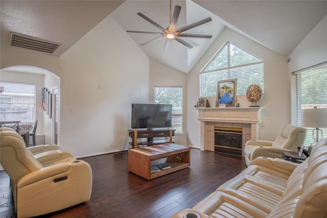 9434 Barretts Glen Ct, Houston, TX 77065 - living area with ceiling fan, arched walkways, lofted ceiling, dark wood finished floors, and a tile fireplace