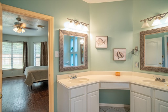 9434 Barretts Glen Ct, Houston, TX 77065 - bathroom featuring double vanity, ceiling fan, wood finished floors, and ensuite bathroom
