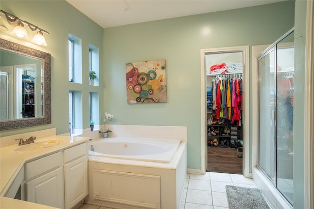 9434 Barretts Glen Ct, Houston, TX 77065 - full bath with tile patterned floors, vanity, a walk in closet, a bath, and a shower stall