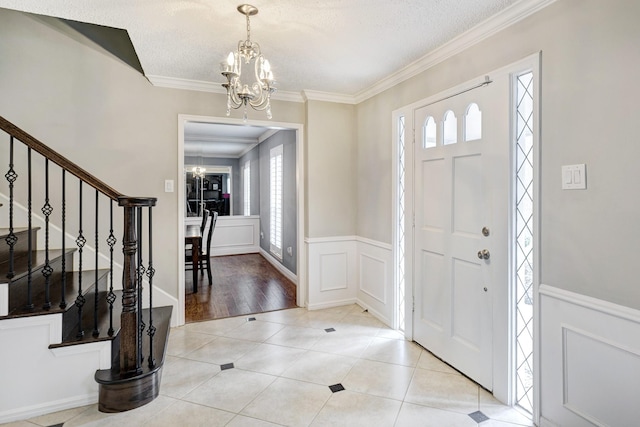 1109 Cheshire Ln, Houston, TX 77018 - foyer entrance featuring a chandelier, healthy amount of natural light, stairs, crown molding, and wainscoting