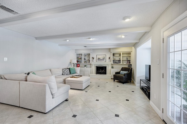 1109 Cheshire Ln, Houston, TX 77018 - living room with beam ceiling, healthy amount of natural light, a fireplace with raised hearth, a textured ceiling, and light tile patterned flooring