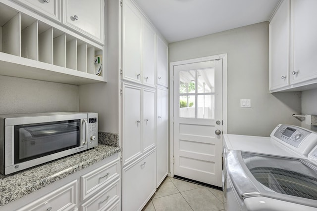 1109 Cheshire Ln, Houston, TX 77018 - washroom featuring washer and clothes dryer, light tile patterned flooring, and cabinet space