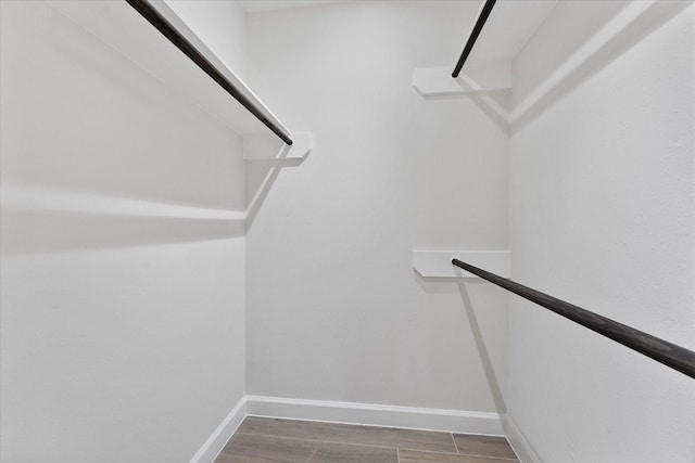 163 W Village Knoll Cir, The Woodlands, TX 77381 - walk in closet featuring wood finished floors