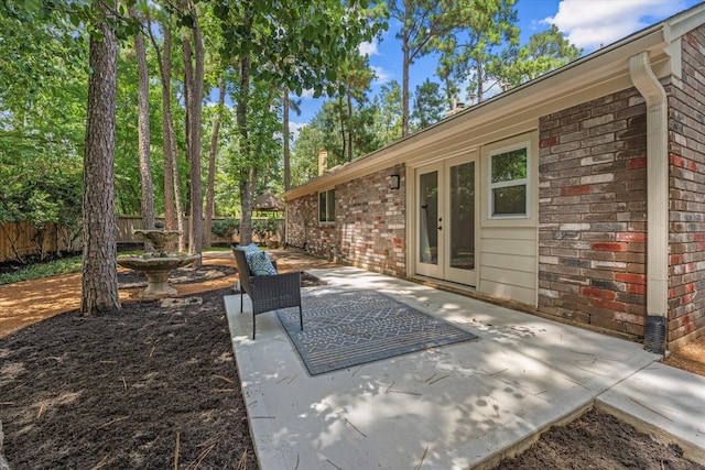 163 W Village Knoll Cir, The Woodlands, TX 77381 - fenced backyard with a patio area and french doors