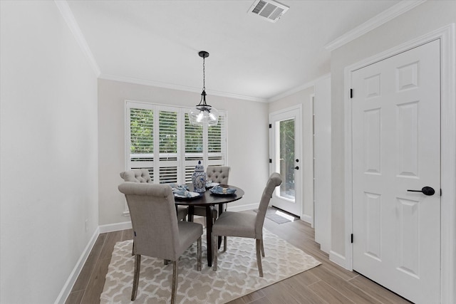 163 W Village Knoll Cir, The Woodlands, TX 77381 - dining area featuring crown molding and wood finished floors