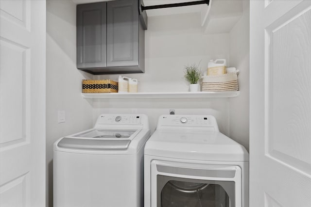 163 W Village Knoll Cir, The Woodlands, TX 77381 - laundry area featuring cabinet space and washer and clothes dryer
