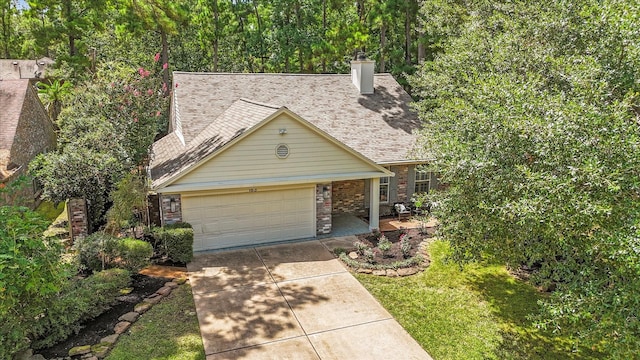 163 W Village Knoll Cir, The Woodlands, TX 77381 - view of front of property featuring driveway, a garage, a shingled roof, a chimney, and brick siding