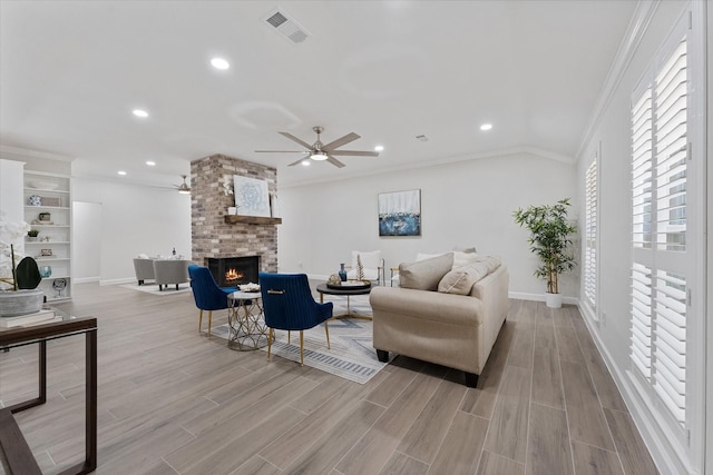 163 W Village Knoll Cir, The Woodlands, TX 77381 - living area featuring a ceiling fan, a brick fireplace, ornamental molding, wood finished floors, and recessed lighting