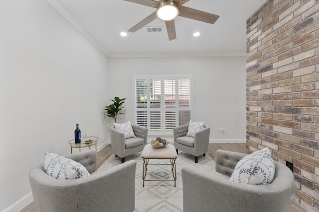 163 W Village Knoll Cir, The Woodlands, TX 77381 - living room featuring ceiling fan, crown molding, recessed lighting, light wood finished floors, and brick wall