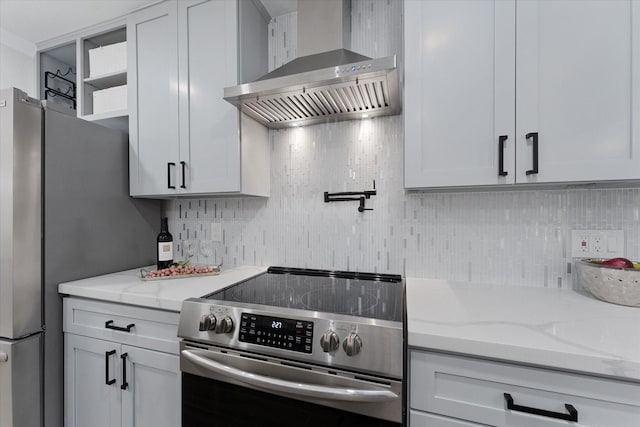 163 W Village Knoll Cir, The Woodlands, TX 77381 - kitchen with stainless steel appliances, wall chimney exhaust hood, tasteful backsplash, and light stone countertops