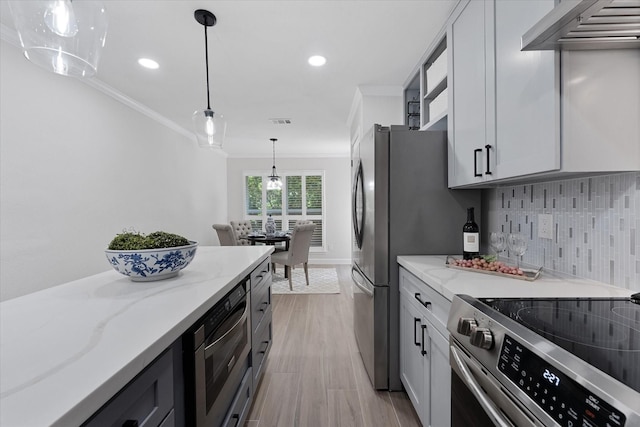 163 W Village Knoll Cir, The Woodlands, TX 77381 - kitchen with ornamental molding, appliances with stainless steel finishes, light stone countertops, backsplash, and recessed lighting