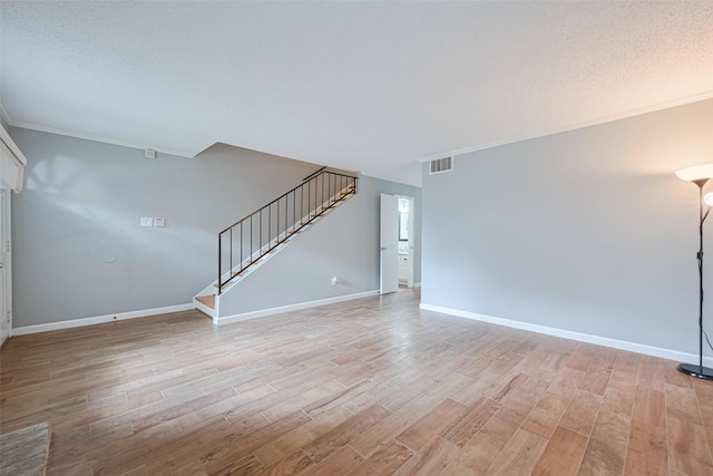 6452 Kentwick Dr, Houston, TX 77084 - unfurnished living room featuring stairway, light wood finished floors, and ornamental molding