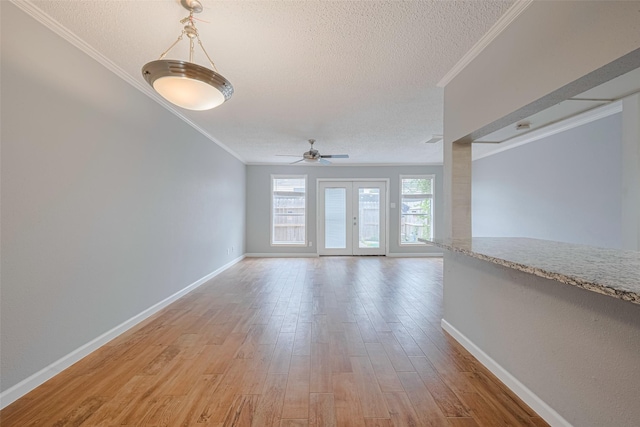 6452 Kentwick Dr, Houston, TX 77084 - empty room with a textured ceiling, a ceiling fan, crown molding, and light wood-style floors