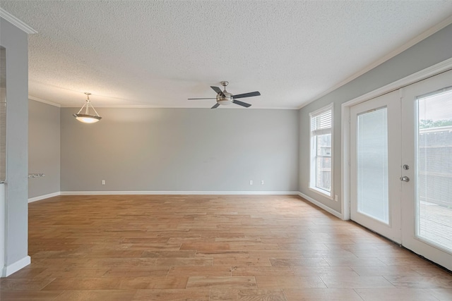6452 Kentwick Dr, Houston, TX 77084 - empty room with ornamental molding, a textured ceiling, light wood-style floors, ceiling fan, and french doors