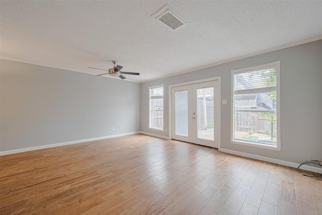 6452 Kentwick Dr, Houston, TX 77084 - spare room with a textured ceiling, plenty of natural light, light wood-type flooring, a ceiling fan, and crown molding