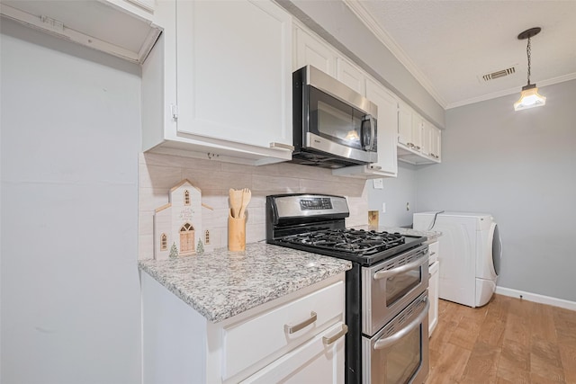 6452 Kentwick Dr, Houston, TX 77084 - kitchen featuring stainless steel appliances, washer / dryer, ornamental molding, decorative backsplash, and light wood finished floors