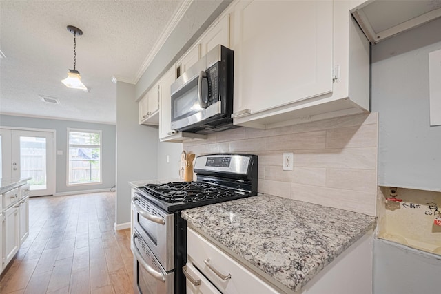 6452 Kentwick Dr, Houston, TX 77084 - kitchen with appliances with stainless steel finishes, ornamental molding, a textured ceiling, decorative backsplash, and white cabinetry