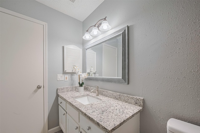 6452 Kentwick Dr, Houston, TX 77084 - bathroom featuring vanity and a textured ceiling