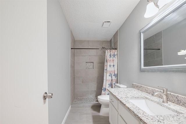 6452 Kentwick Dr, Houston, TX 77084 - bathroom featuring vanity, tiled shower, and a textured ceiling