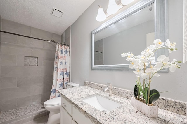 6452 Kentwick Dr, Houston, TX 77084 - bathroom featuring vanity, tiled shower, and a textured ceiling