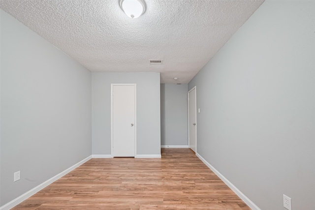 6452 Kentwick Dr, Houston, TX 77084 - empty room with light wood-style floors and a textured ceiling