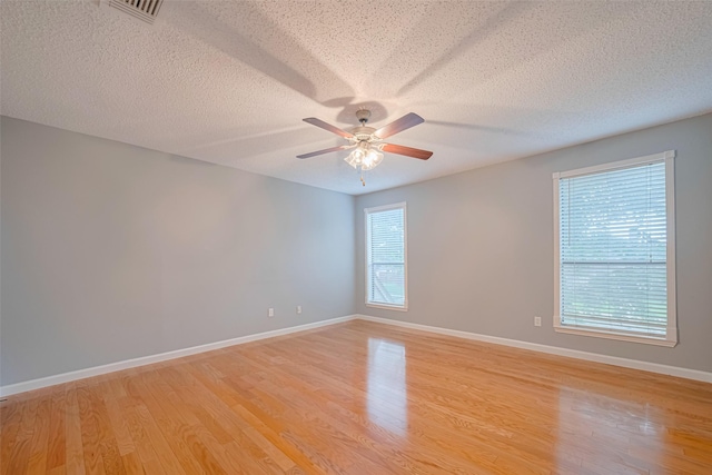 6452 Kentwick Dr, Houston, TX 77084 - empty room with light wood-style floors, ceiling fan, and a textured ceiling
