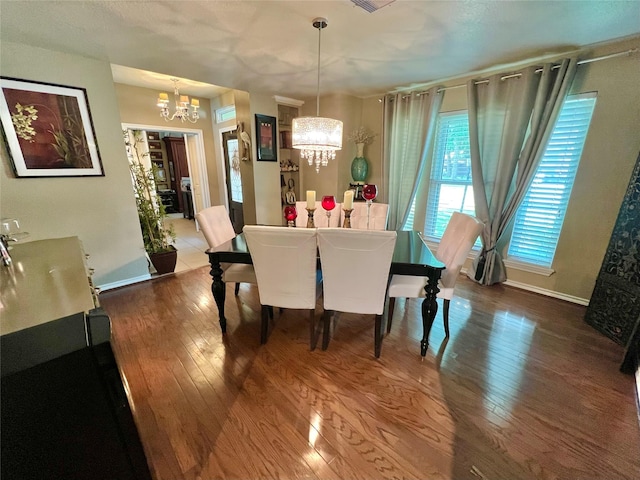 51 S Trillium Ct, Lake Jackson, TX 77566 - dining room featuring a chandelier and hardwood / wood-style floors