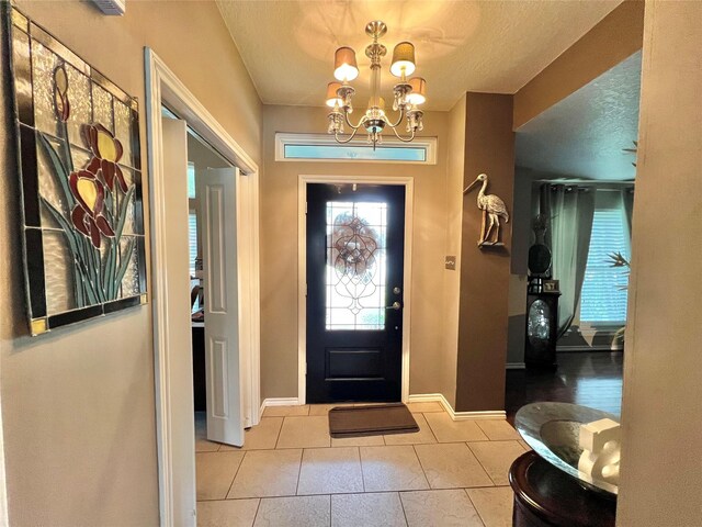 51 S Trillium Ct, Lake Jackson, TX 77566 - foyer with a chandelier, tile patterned flooring, and a textured ceiling