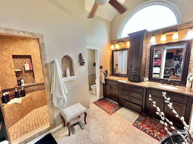 51 S Trillium Ct, Lake Jackson, TX 77566 - full bath with double vanity, tile patterned flooring, ceiling fan, a textured wall, and walk in shower