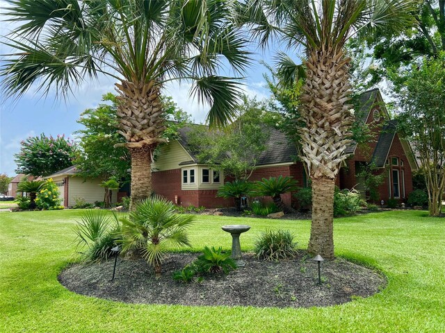 51 S Trillium Ct, Lake Jackson, TX 77566 - view of green lawn featuring an attached garage