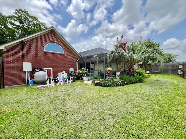51 S Trillium Ct, Lake Jackson, TX 77566 - rear view of property featuring brick siding, a fenced backyard, and a lanai