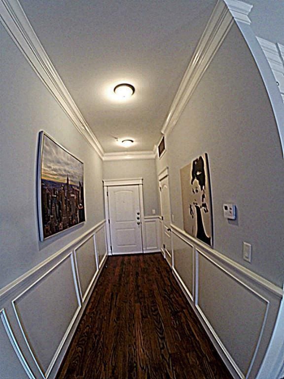 2802 Morrison St Unit 401, Houston, TX 77009 - corridor featuring a decorative wall, ornamental molding, dark wood-style floors, wainscoting, and arched walkways