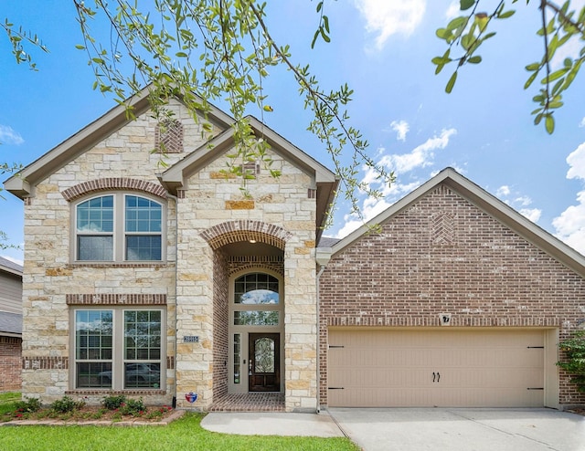 28915 Crested Butte Dr, Katy, TX 77494 - view of front of home featuring stone siding, a garage, driveway, and brick siding
